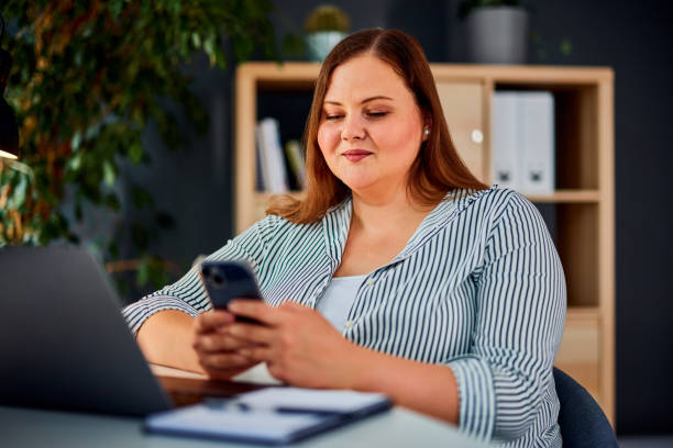 istock A pretty brunette businesswoman using a mobile phone while sitting at home office. 1491270803