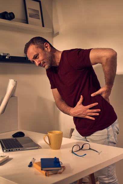 istock Man with hip, back, spine, hernia and sciatica pain at home. 1491274157