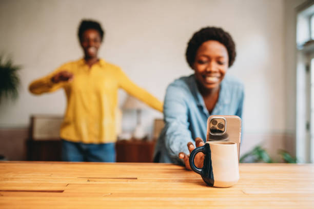 istock Two friends are dancing together at home while they are streaming with a smart phone 1491274221