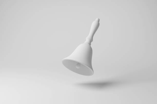istock White handbell floating in mid air with shadow on white background in monochrome. Illustration of the concept of attention and alert 1491277385