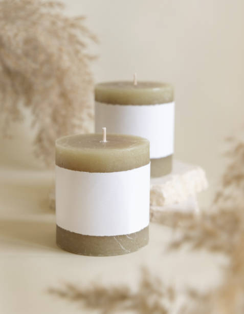 istock Candles with label on beige stone near dried pampas grass close up, copy space, mock up 1491277430