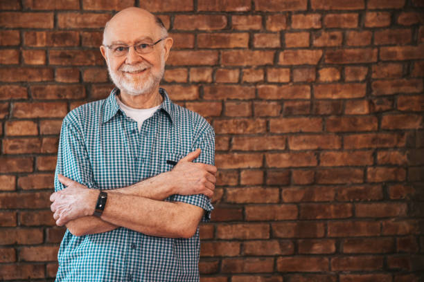 istock Portrait of a senior man against a brick wall 1491279863