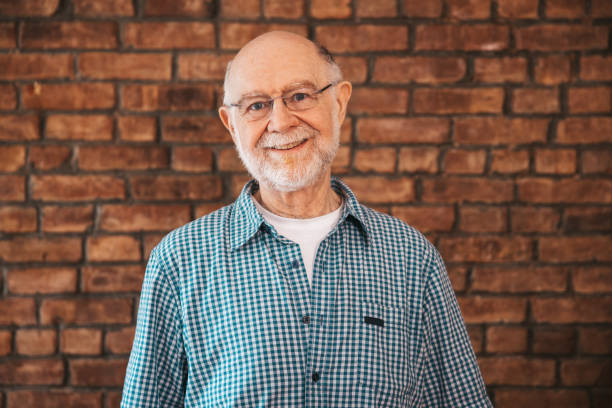 istock Portrait of a senior man against a brick wall 1491280031