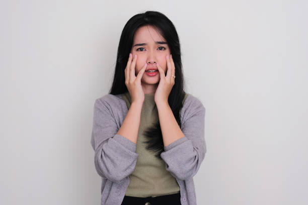 istock Young Asian women touching her face with worried expression 1491281844