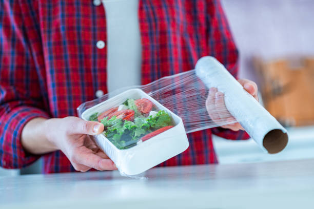 istock Using food polyethylene plastic film for food storage in fridge at home 1491283204