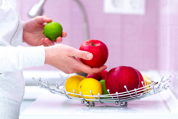 istock Fresh ripe fruit bowl on table in kitchen at home. Vitamins, eco-friendly organic products for healthy snack. Clean food, proper nutrition. Dieting 1491285375
