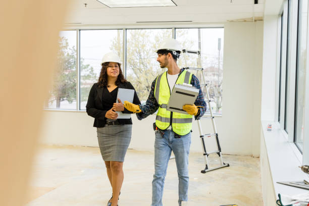 istock Male foreman talks with the female engineer at the construction site 1491287495