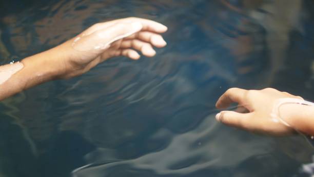 istock Boy's hands are in the clear water, floating 1491287869