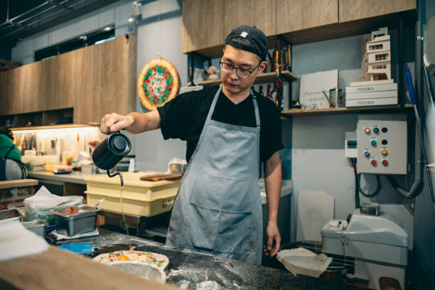 istock At the restaurant, a pizza chef is preparing pizza on the workstation. 1491289821