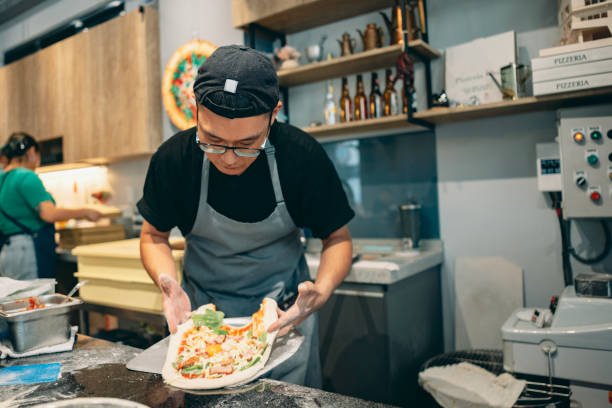 istock At the restaurant, a pizza chef is preparing pizza on the workstation. 1491289822