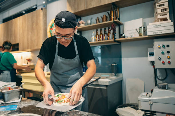 istock At the restaurant, a pizza chef is preparing pizza on the workstation. 1491289824