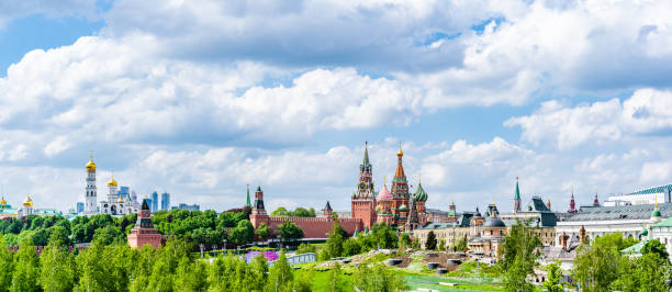 Moscow Kremlin panorama in a sunny day, Spasskaya Tower, and St. Basil's Cathedral from Zaryadye Park. stock photo
