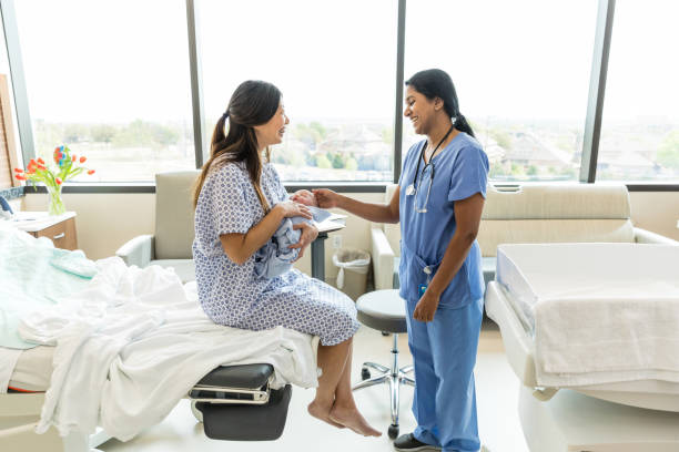 istock New mom holds baby while chatting with female doctor 1491291624