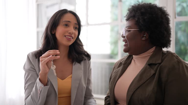 Women on a real estate meeting and celebrating new house keys