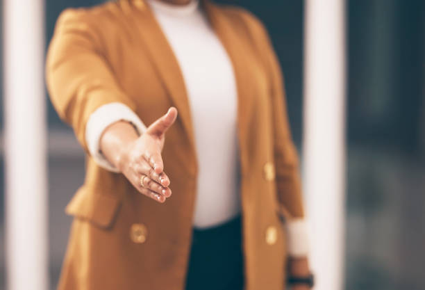 istock Professional woman with a handshake gesture for greeting, welcome or partnership in office. Company, corporate and female employee stretching hand for shaking hands for agreement in modern workplace. 1491297962