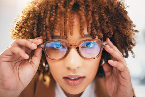 Vision, glasses and black woman, face and portrait with eye care, designer frame with prescription lens. Closeup, optometry and hands holding spectacles with female, fashion and health for eyes