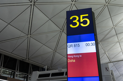 Hong Kong - February 20, 2023 : Departure gate for flight operated by Qatar Airways at Hong Kong International Airport.