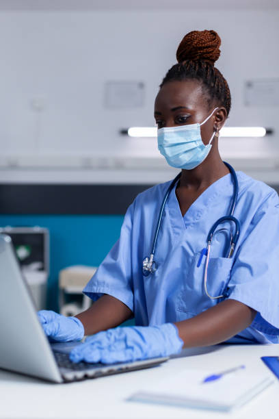 istock Black woman with nurse profession using modern laptop 1491300812