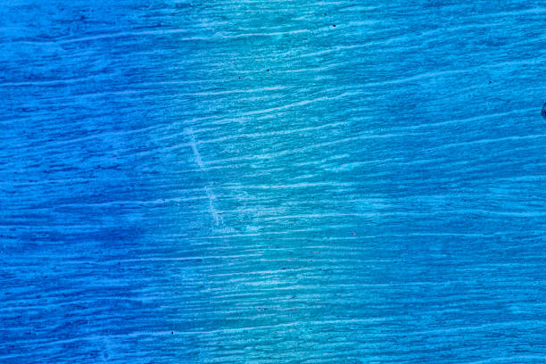 Cracked background with several scratch marks, wood texture with light blue and blue tones. Old wooden background, with medium light stripes.