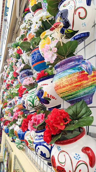 Rows of colorful flower pot on a wall in Cordoba Spain