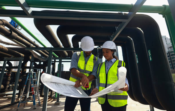 istock System Engineer team check the drawing audit  with actual piping system of new construction project, mechanical engineers check cooling sysetm compare with design drawing 1491304452
