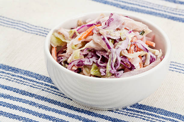coleslaw side dish bowl of coleslaw salad - side dish on a tablecloth coleslaw stock pictures, royalty-free photos & images