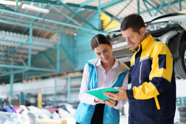 istock Woman and technician talking together in garage. 1491306910