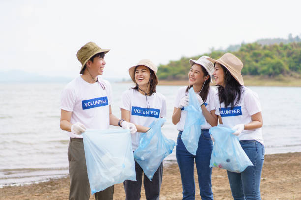 istock Group of volunteer collecting a garbage. 1491307379