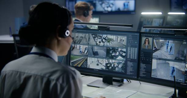 istock Employees work on PC in security control center, watch CCTV cameras 1491310526