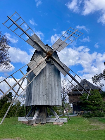 a windmill in nature, garden, trees