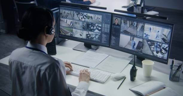 istock Female employee works in security control center 1491311560