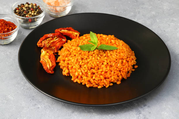 istock Traditional turkish bulgur pilaf with tomato sause in plate (Turkish name; meyhane pilavi) 1491312013