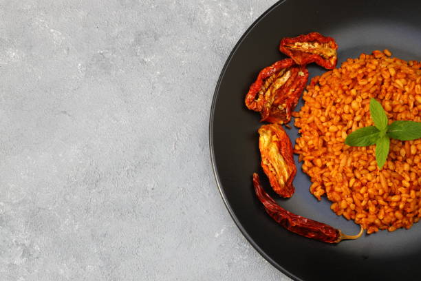 istock Traditional turkish bulgur pilaf with tomato sause in plate (Turkish name; meyhane pilavi) 1491312975