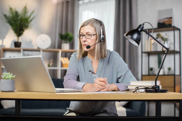 istock Middle-aged woman holding online conference at remote work 1491313428