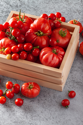 Tomatoes on wooden background, freshly picked red tomato fruit frame, cooking background, copy space