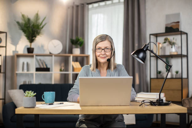 istock Remote employee sitting with laptop at desk in workplace 1491313437