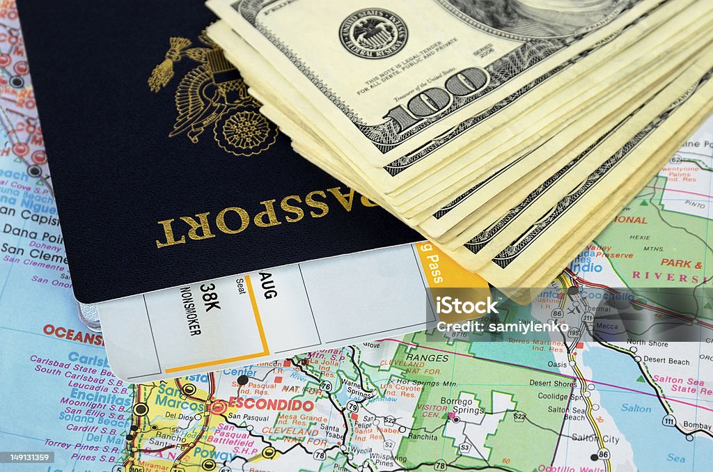 Passport book and tickets on a road map Passport book and tickets on a map and money Airplane Ticket Stock Photo