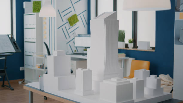 istock Concept of building model and construction design on table in empty workplace 1491313674
