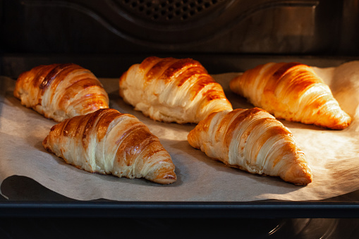 Croissants on a baking sheet in the oven