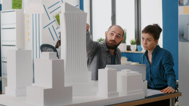 istock Team of architects designing building model on laptop in architectural office 1491313948