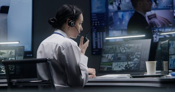 istock Female officer works on computer with CCTV cameras footage 1491314719