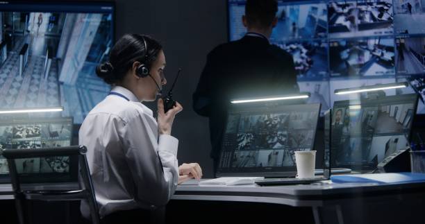 istock Female officer works on computer with CCTV cameras footage 1491314856