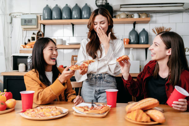 istock Group of friends talking and laughing together while eating ital 1491315186