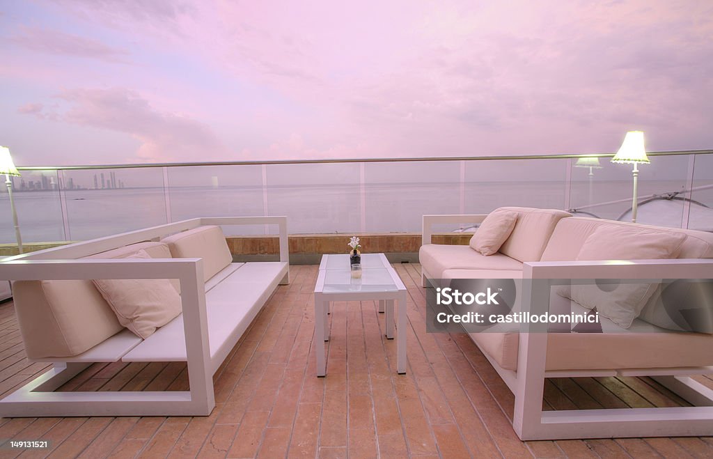 Cozy outdoor chairs and a couch to enjoy the sunset Stunning view of outdoor chairs and a couch to enjoy the sunset of the beach Outdoors Stock Photo