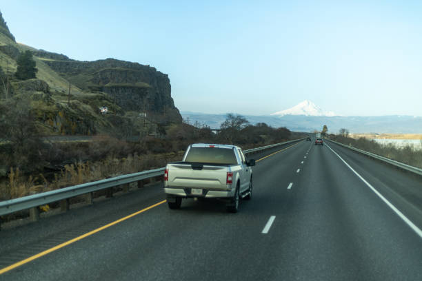 istock A car driving on the highway with a mountain in the background. 1491315269