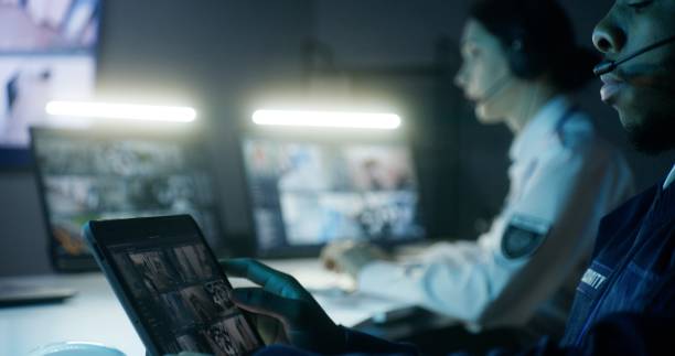 istock Security officers in headsets control CCTV cameras 1491316331