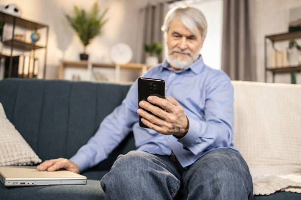 istock Elderly adult using leisure time for smart gadgets at home 1491316879