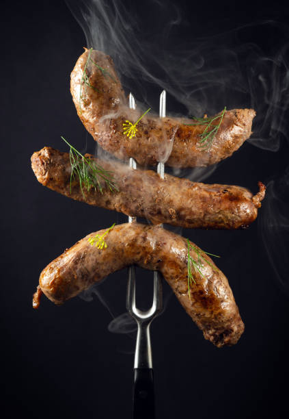 istock Steamed hot fried Bavarian sausages with dill on a fork. Idea for hotel menu or recipe 1491316909