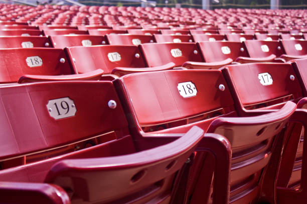 istock Red folding empty stadium seats with metal seat number plaques 1491318512