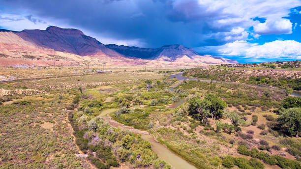 istock River through valley with mountains and storm cloud in distance 1491318686